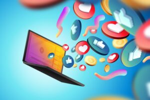 Tela de notebook aberta com vários ícones saindo em 3D